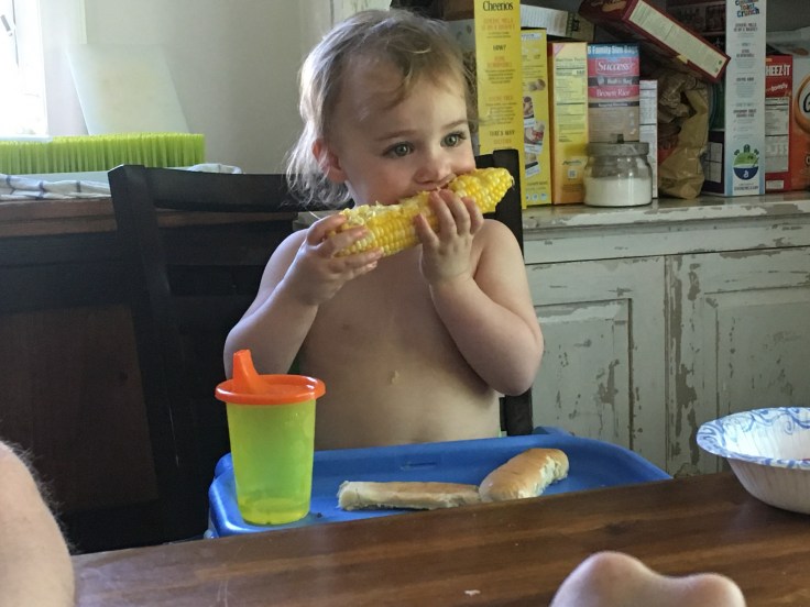 baby eating corn on the cob