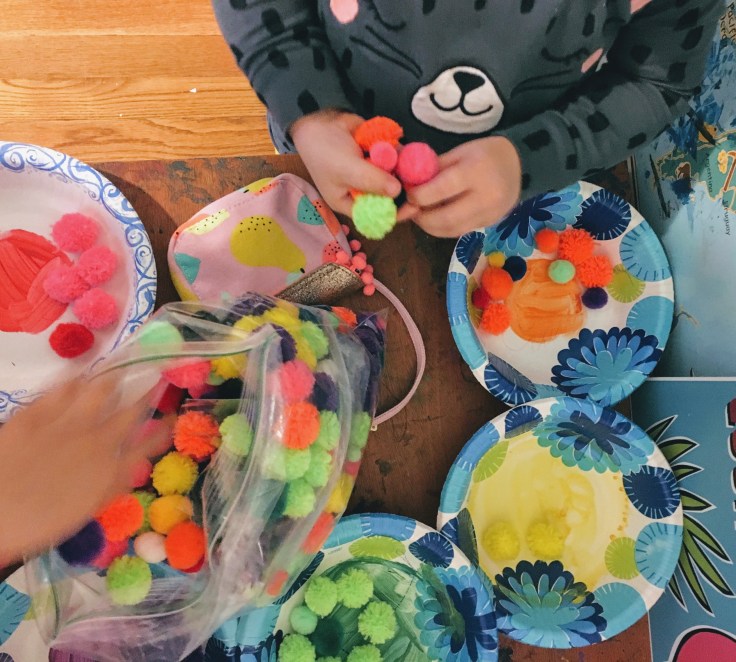 Sensory play organizing poms.