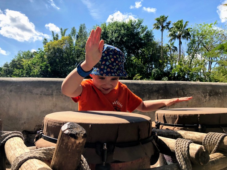 Reece keeping a beat, hitting the drums at Animal Kingdom