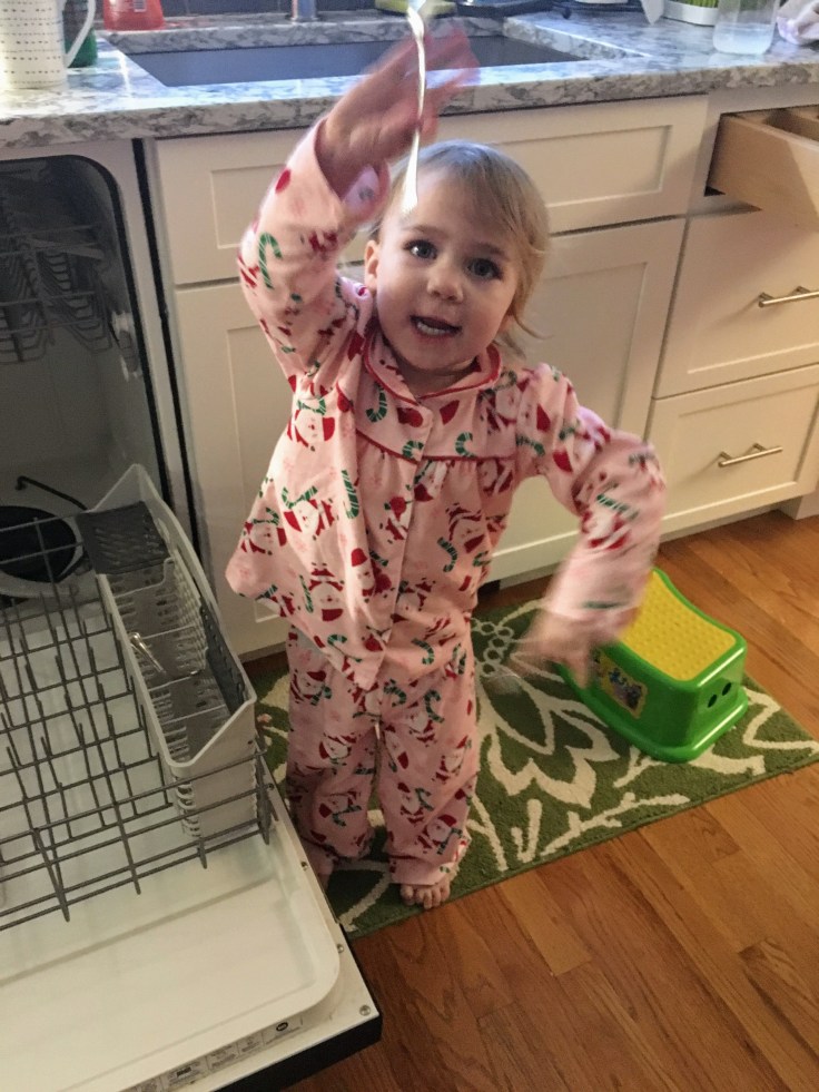Kat emptying the dishwasher