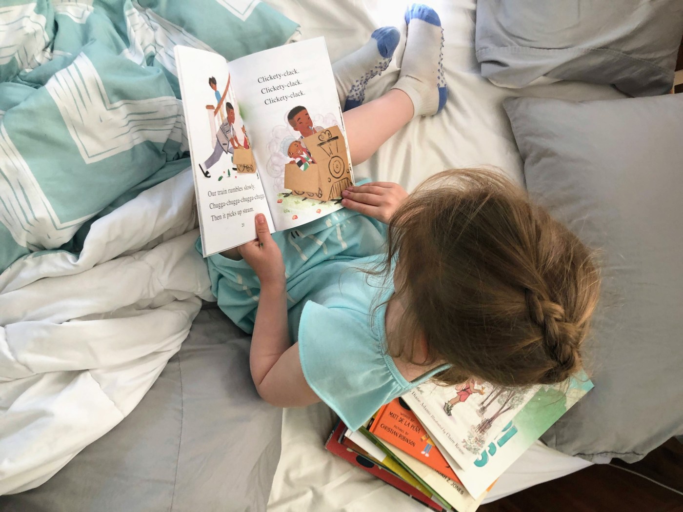 Kat reading beginner reader book in bed